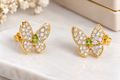 Elegant Butterfly Crystal Stud Earrings – Gold Finish with Mint Green Stone